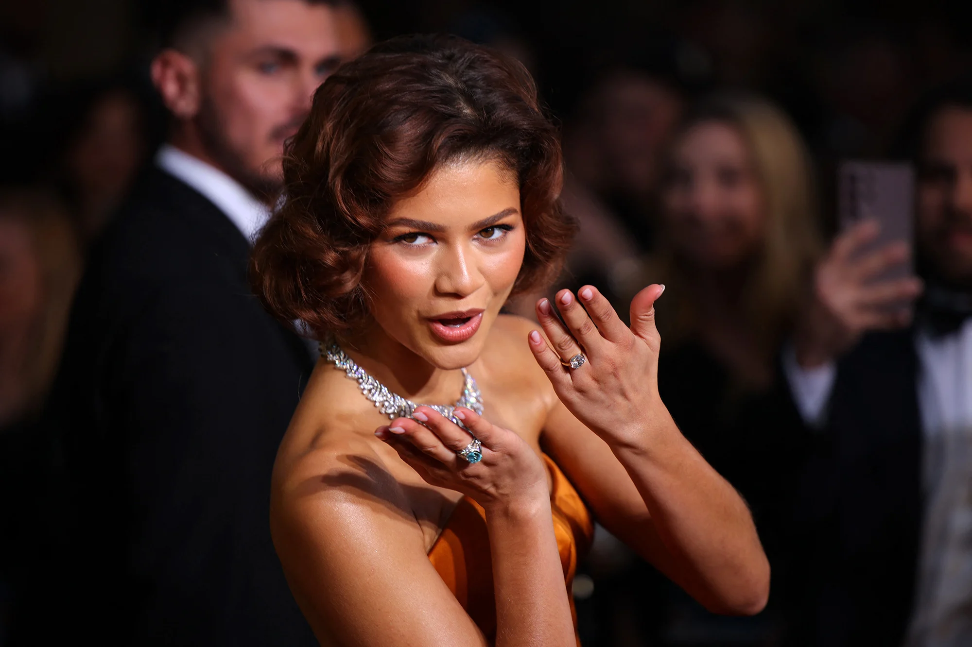 Zendaya radiates Old Hollywood glamour in an elegant gown, sparking speculation about a diamond ring.