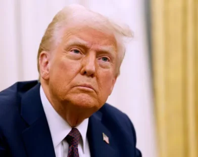 Former President Donald Trump speaking at a podium with a concerned expression, referencing a briefing on a 'terrible accident' at an airport